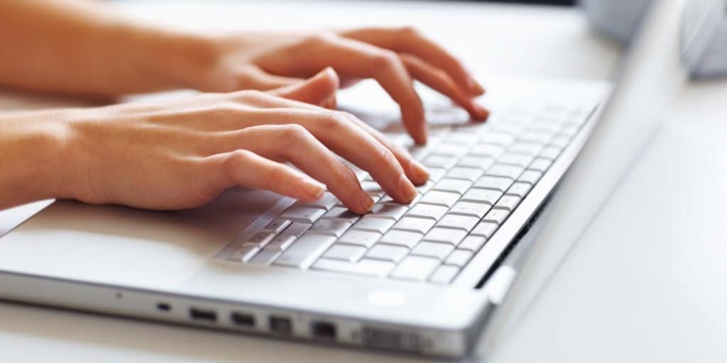 Businesswoman typing on laptop