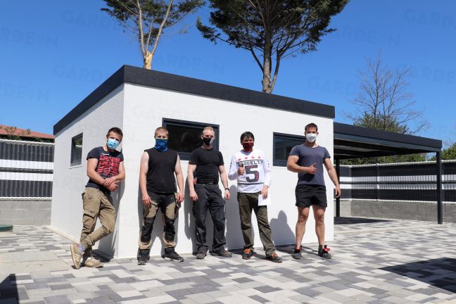 Montážnici pri montáži záhradného domčeka