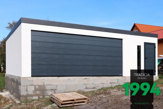 Atypická garáž v bielej farbe s tmavou atikou