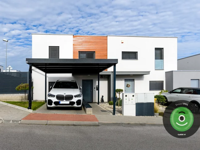 Bíle auto pod přístřeškem