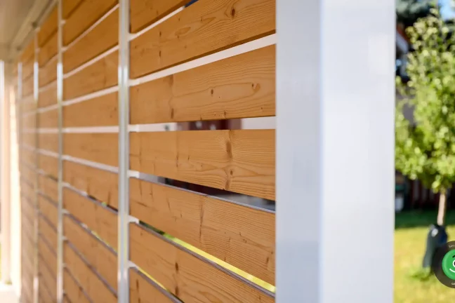 Detail hnědé dřevěné výplně na přístřešku pro dvě auta