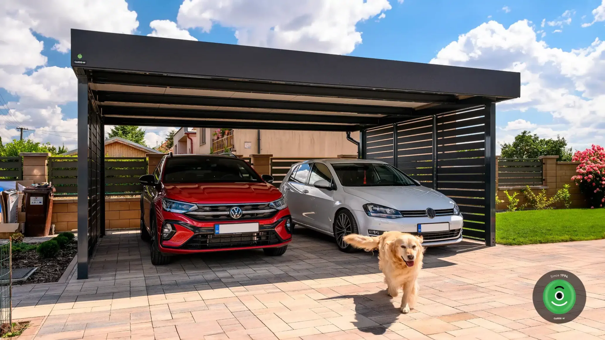 Ocelový přístřešek pro dvě auta s červeným a bílým autem uvnitř