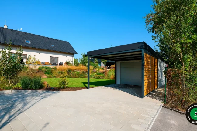 Estetická jednogaráž s krytým přístřeškem vedle stavby.