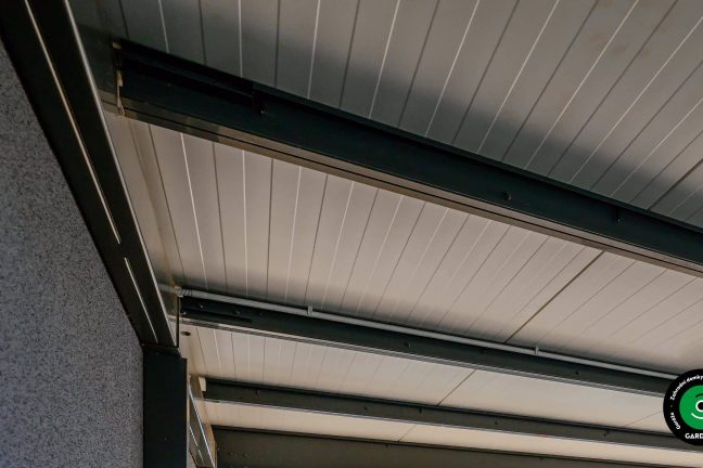 Detail konstrukce střechy s ocelovými nosníky a panely.