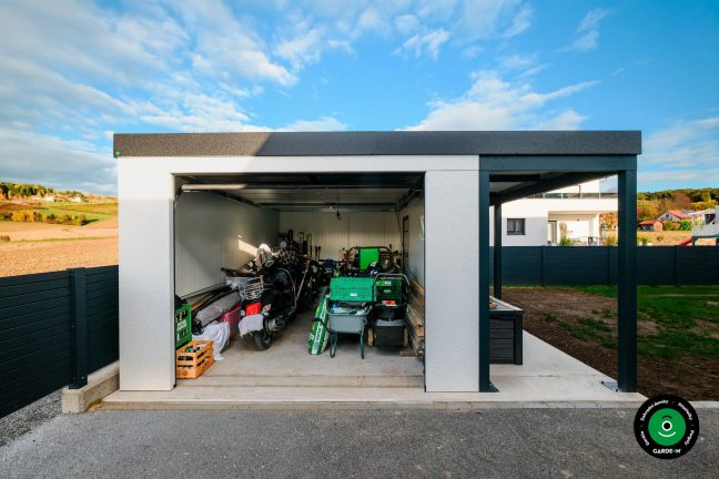 Otevřená garáž plná nářadí a uložených motorek